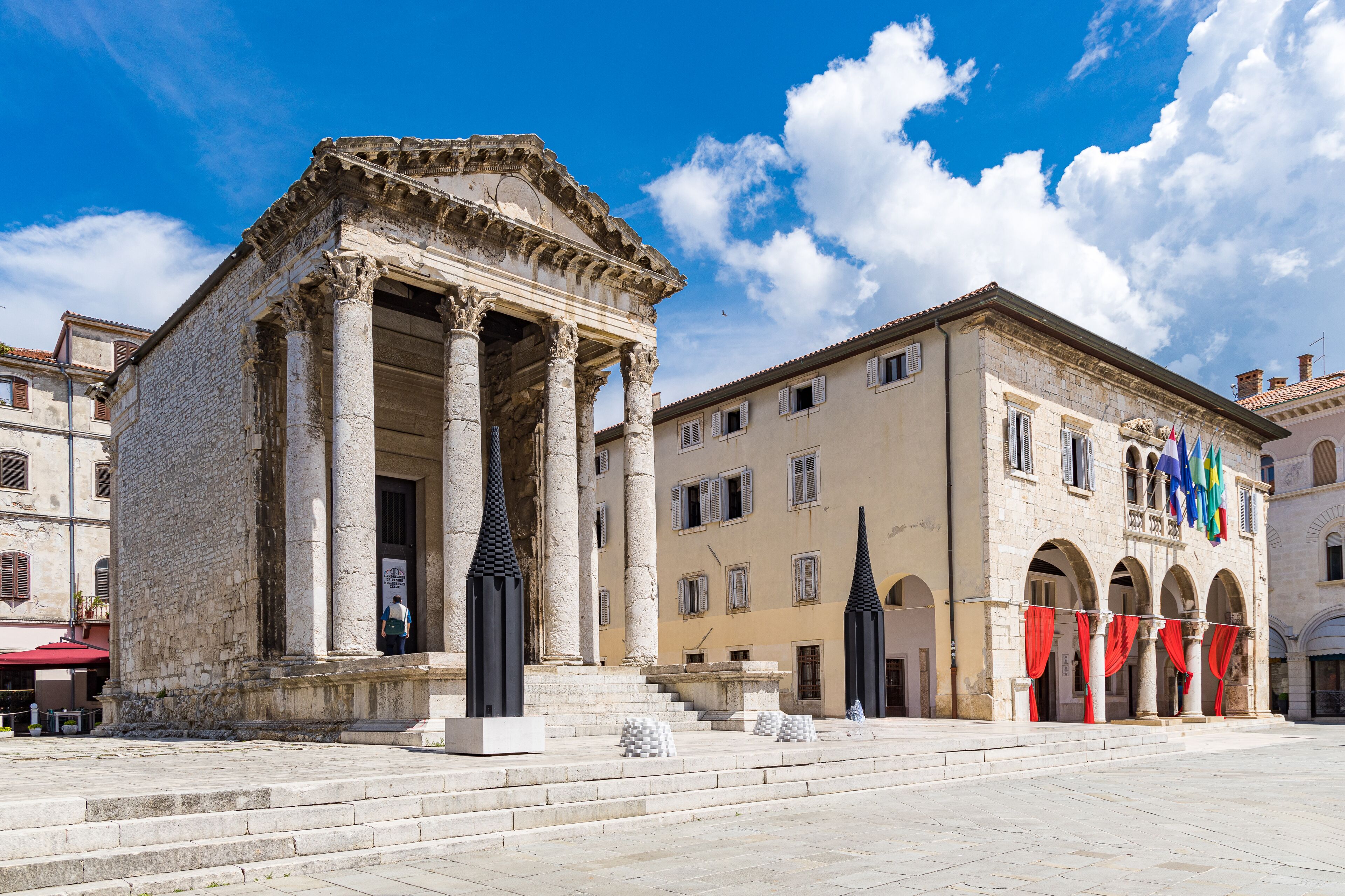 A historical building with classical architecture, featuring columns and a central entrance.