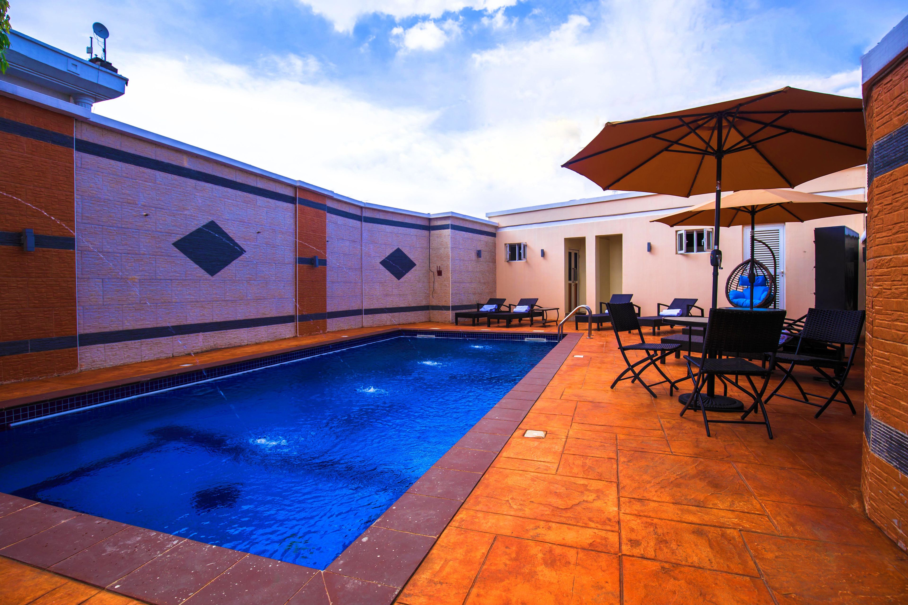 outdoor pool, open 10:00 am to 7:00 pm, pool umbrellas