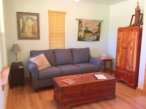 Relax in this inviting living room with a sofa, coffee table, and a cozy reading nook.