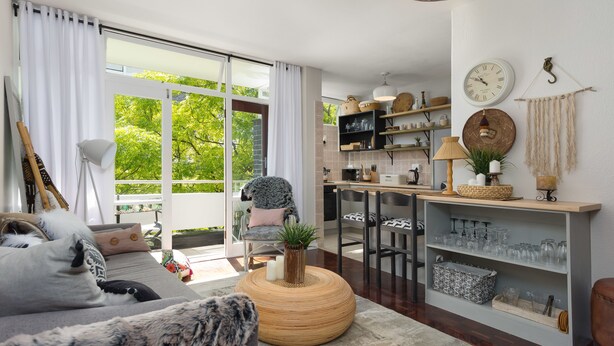 A modern living room with a sofa, coffee table, and a view of the outdoors. - St Martini 416 (Cape Town)
