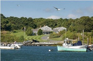 Enjoy serene lakeside views from the expansive porch of this peaceful retreat, where you can moor your boat and unwind in a lush, natural setting.