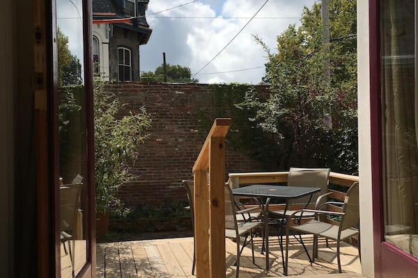 View from kitchen of neighboring Victorian mansion and deck