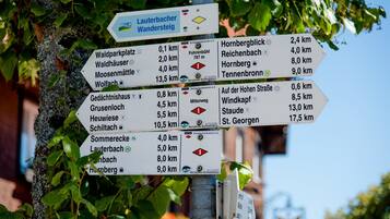 A directional signpost with multiple destination markers, including distances and directions to various local attractions.