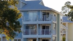 A multi-story residential building with balconies, a covered front porch, and a driveway. - Updated condo with a fantastic view!



 (Calabash)