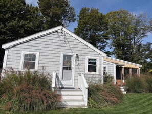 A two-story house with a front porch, a visible number '433', and a wooden extension on the right.