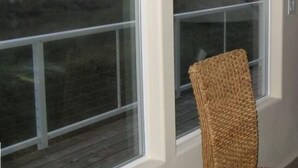 A room with a large window overlooking a beach with rocks and dunes. - Ocean Front ON the Beach - Spectacular Views! 14 Minutes to Bandon Dunes Golf! (Bandon)