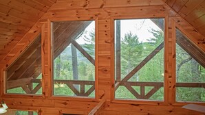 A wooden cabin with large windows and a sloped roof. - *Beautiful Cabin With Gorgeous Views and Privacy*-Sunset Ridge (Sevierville)