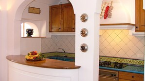 A kitchen with a wooden countertop, a sink, and a tiled backsplash. - great sea view - great position - not far from the town center (Positano)