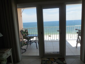 A room with a sliding glass door leading to a balcony with a view of the ocean. - SEACREST 809, CORNER UNIT,2 PRIVATE BALCONIES/GULF FRONT & LAGOON (Gulf Shores)