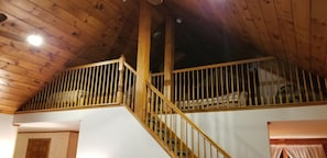 A wooden staircase with a railing leading to a lofted area. - Western Catskills Paradise - Four-Season Mountaintop Retreat (Bainbridge)