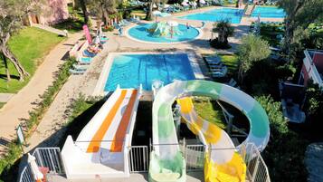 A water park with multiple pools, slides, and lounge areas.