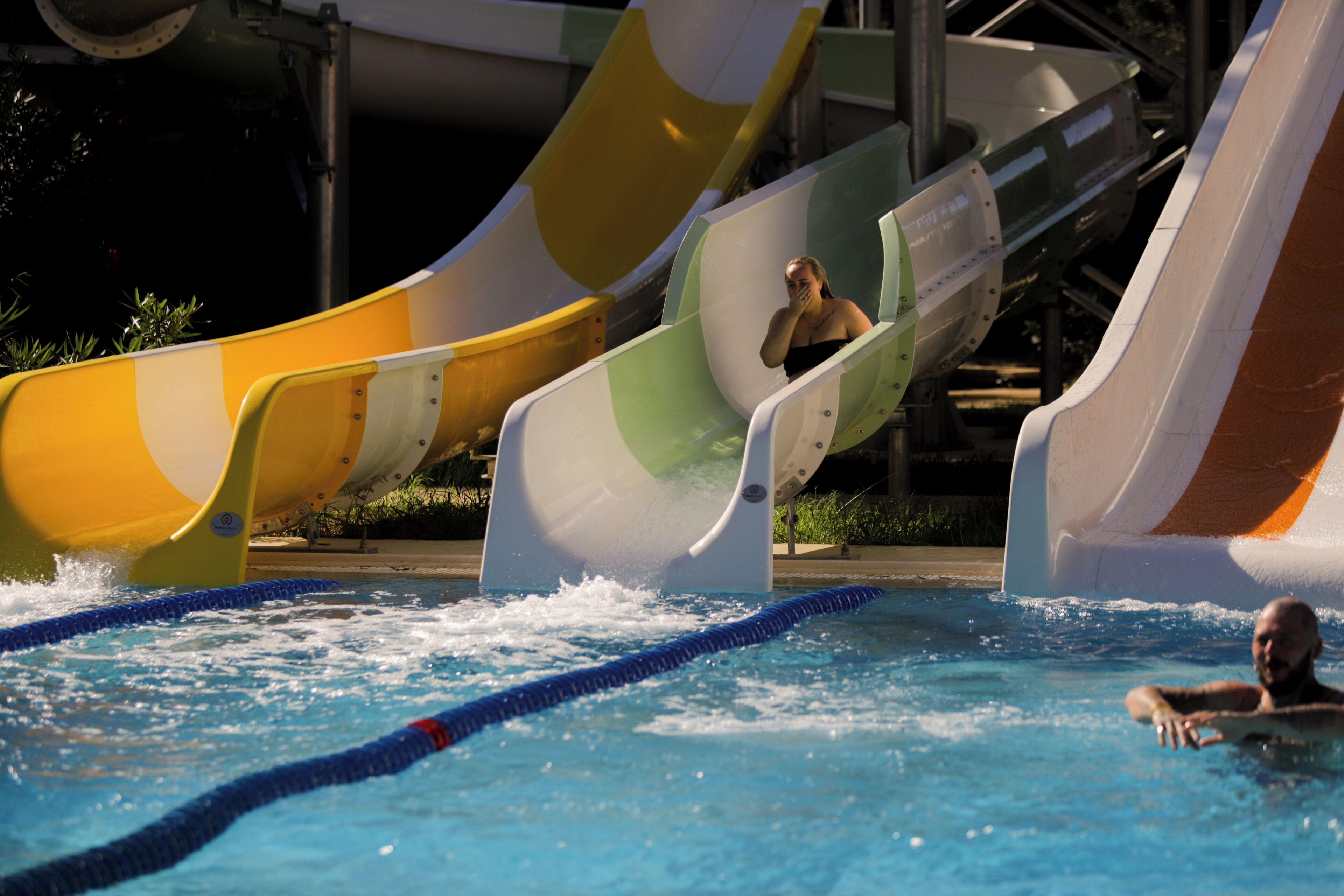 A water park with multiple water slides and a swimming pool.
