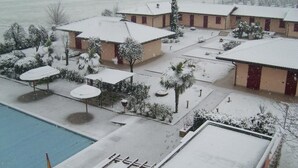 A hotel with multiple buildings, a swimming pool, and snow-covered surroundings. - Hotel Giannina (Forlimpopoli)