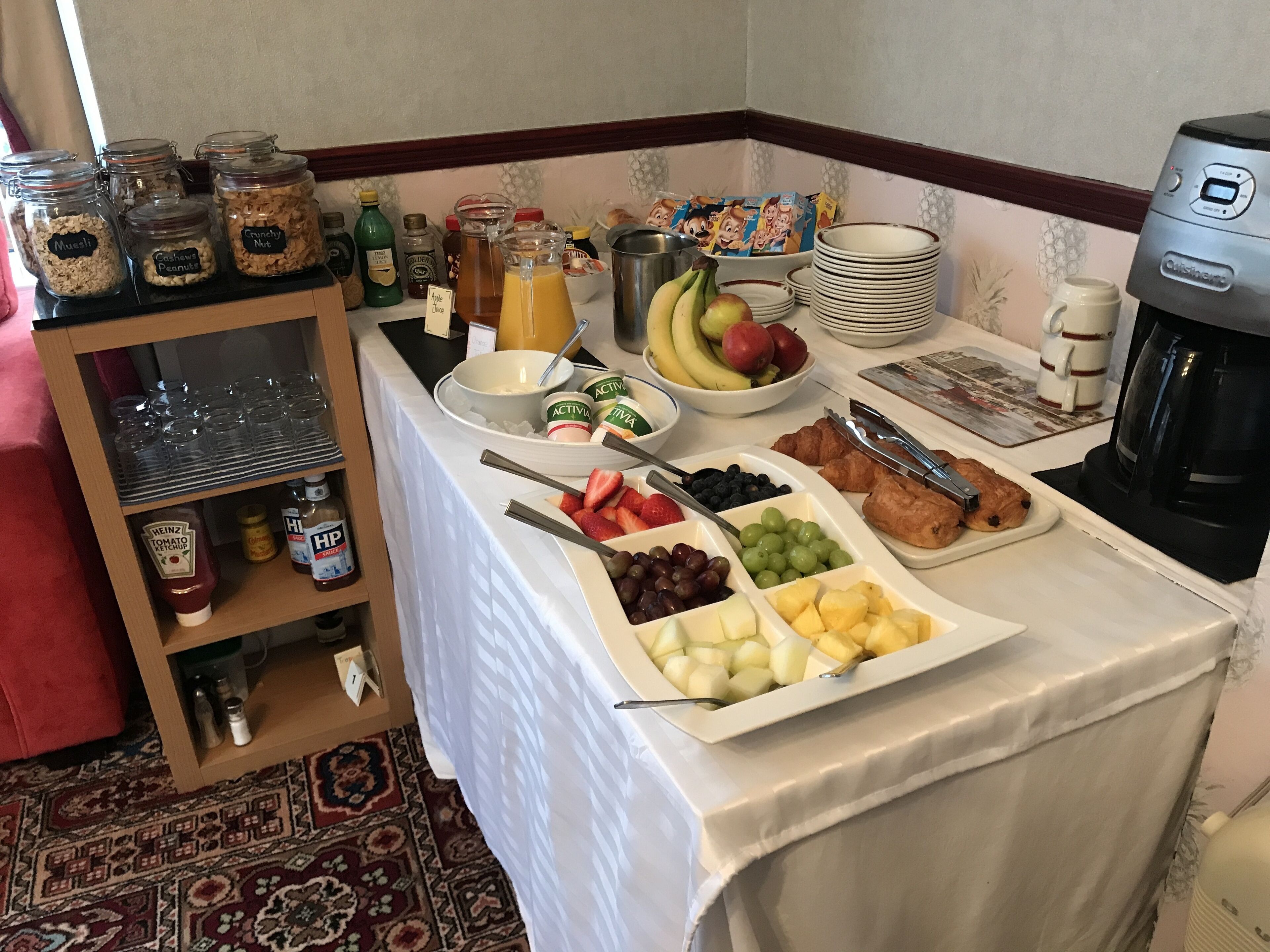 A breakfast buffet with various food items and condiments.