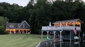 A lakeside property with a house, a dock, and a boat. - ON LAKE BURTON! LAKE HOUSE WITH BOAT DOCK! BOAT AVAILABLE FOR RENT! (Clarkesville)