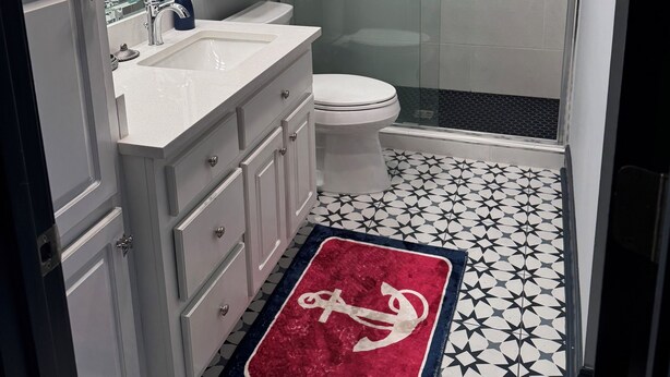 A modern bathroom with a glass-enclosed shower, a white sink, and a toilet. - ON LAKE BURTON! LAKE HOUSE WITH BOAT DOCK! BOAT AVAILABLE FOR RENT! (Clarkesville)