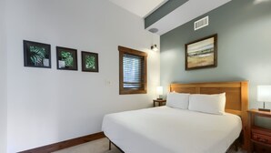 A neatly made bed with a wooden headboard, a bedside table with a lamp, and a window with blinds. - High Point Chateau 4 Bedroom Home by RedAwning (Breckenridge)