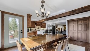 A spacious kitchen with a large island, wooden cabinets, and a chandelier. - High Point Chateau 4 Bedroom Home by RedAwning (Breckenridge)