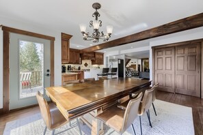 A spacious kitchen with a large island, wooden cabinets, and a chandelier. - High Point Chateau 4 Bedroom Home by RedAwning (Breckenridge)