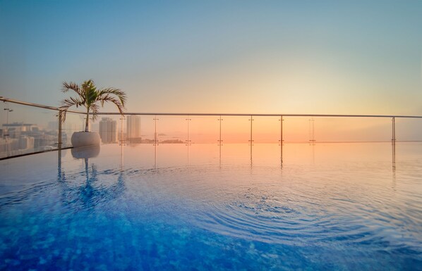 Outdoor pool, open 6:00 AM to 6:00 PM, pool umbrellas, pool loungers