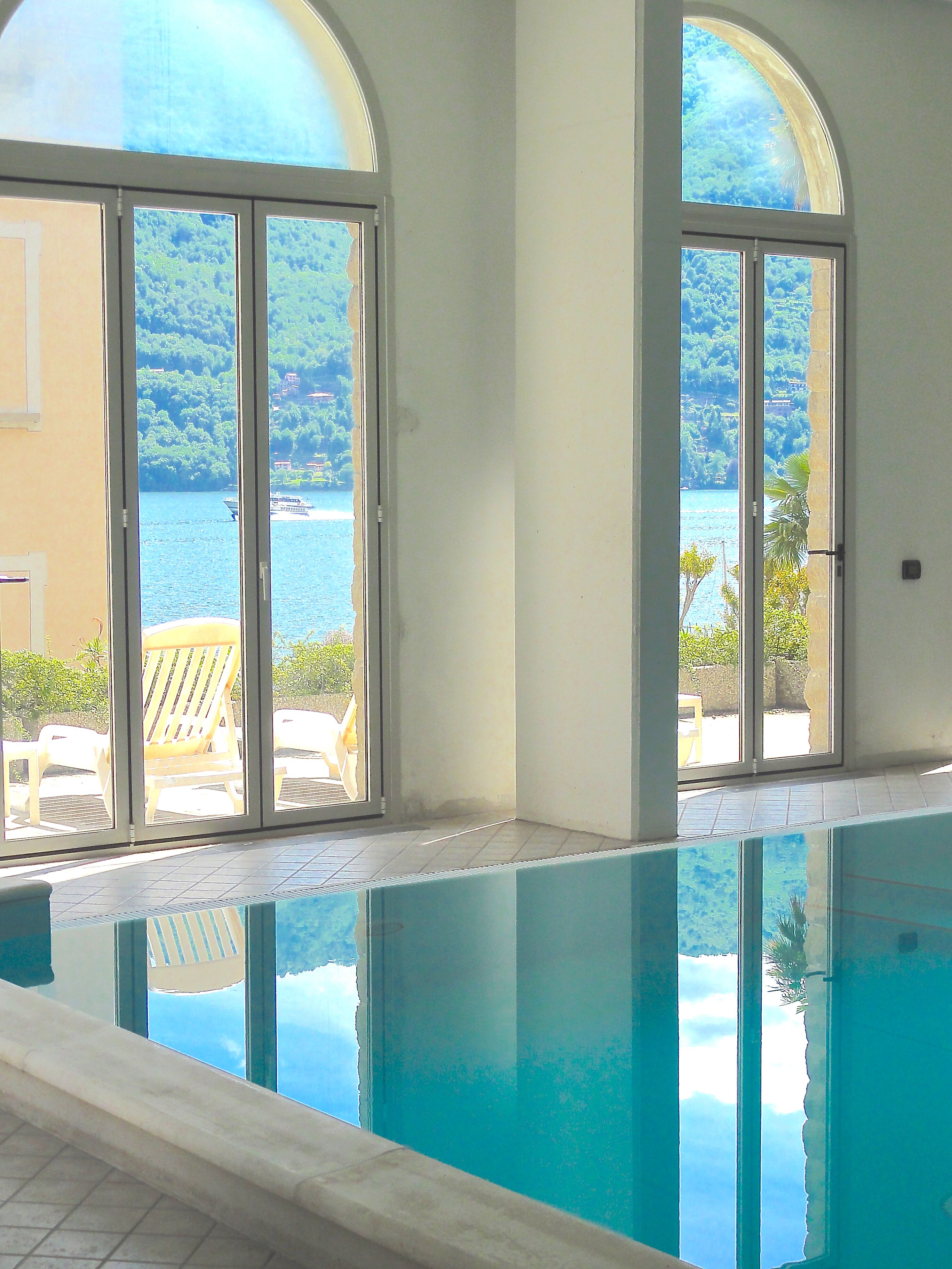 Pool with wonderful views of the lake. Doors open to outside patio in summer!