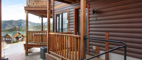 A wooden cabin with a balcony, a window, and a door marked with the number 21B.