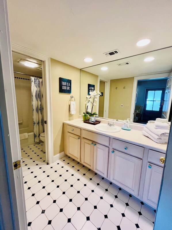 Combined shower/tub, hair dryer, towels, soap