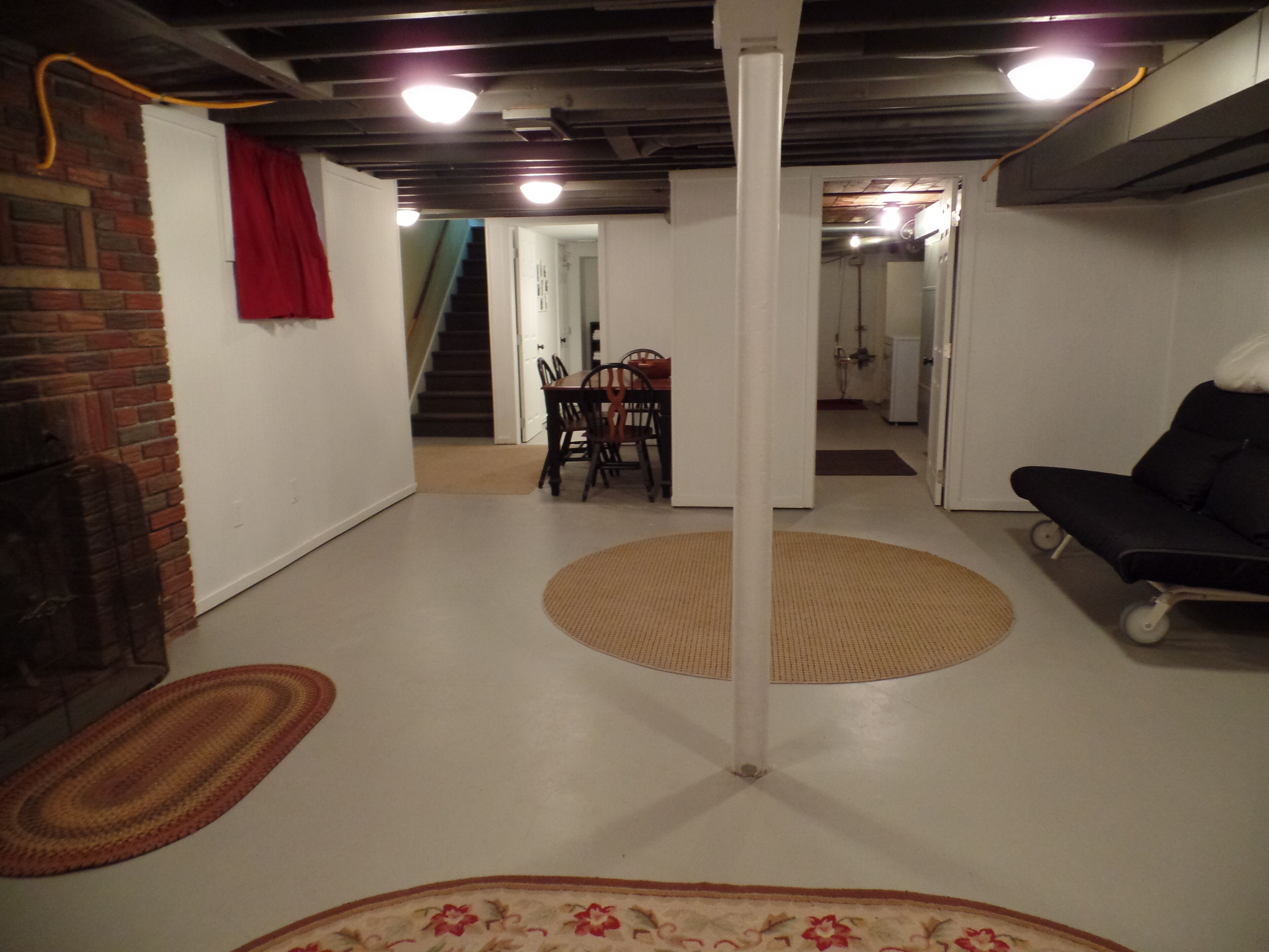 Un vaste espace de vie comprenant une table à manger et des chaises, un canapé et un escalier menant à l’étage supérieur.