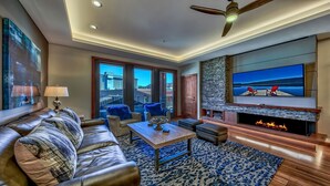 A modern living room with a leather sofa, a coffee table, and a fireplace.