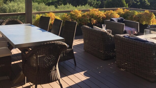 An outdoor patio with wicker furniture, a table, and hanging lights. - Sonoma Valley-Beautiful Glen Ellen Wine Country Retreat - Amenities Galore! (Glen Ellen)