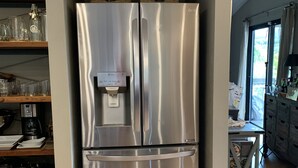 A stainless steel refrigerator with a water dispenser, located in a kitchen with wooden shelves and a wooden table. - Sonoma Valley-Beautiful Glen Ellen Wine Country Retreat - Amenities Galore! (Glen Ellen)
