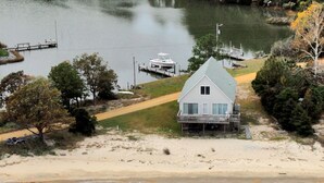 A beach house with a large deck, a dock, and a view of the lake. - Beach Cottage With A Spectacular View ~ Your Own Private Beach ~ Includes Kayaks (Ridge)