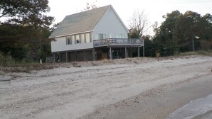 A beachfront house with a balcony overlooking the ocean. - Beach Cottage With A Spectacular View ~ Your Own Private Beach ~ Includes Kayaks (Ridge)