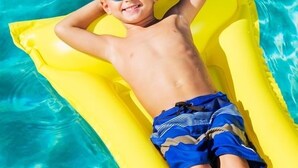 A child lying on a yellow inflatable float in a swimming pool. - 1380 Laurel Grove 3 Bedroom Home by RedAwning (Miramar Beach)