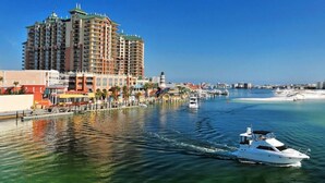 A waterfront hotel with multiple floors, a marina with boats, and a clear view of the ocean. - 1381 Laurel Grove 3 Bedroom Home by RedAwning (Miramar Beach)