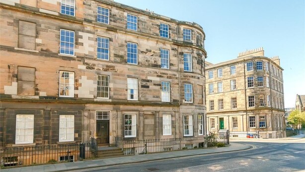 A corner building with multiple windows and a curved facade. - Henderson - New Town Apartment (Edinburgh)
