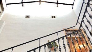A staircase with ornate black balustrades and potted plants. - BirdHouse Valencia (Valencia)