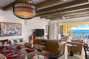Enjoy a formal dining experience in this stylish room, featuring a large dining table, comfortable seating, and a balcony with ocean views.
