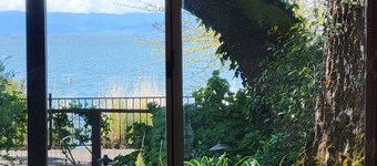 Great Price! Sunset Beach Cottage with Lovely garden, beach, and boat dock!