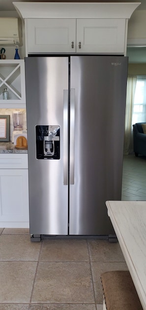 A stainless steel Whirlpool refrigerator with a built-in ice maker, white cabinetry, and a tiled floor. - 1-1/2 Blocks from the beach w/traffic light, Just remodeled   (Ship Bottom)
