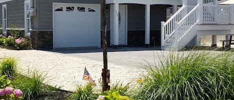 A two-story house with a white balcony and a garage.