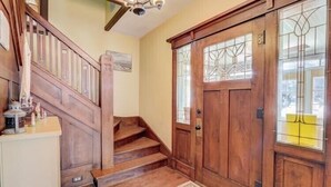 A wooden staircase leading to a door with stained glass panels. - Enjoy Beachfront Living With family!  (Racine)