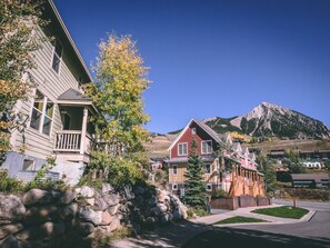 A residential area with houses, a stone wall, and a mountain in the background. - Winter Chalet, pet friendly, shuttle!
Leaves are changing!
Discounted rates! (Crested Butte)