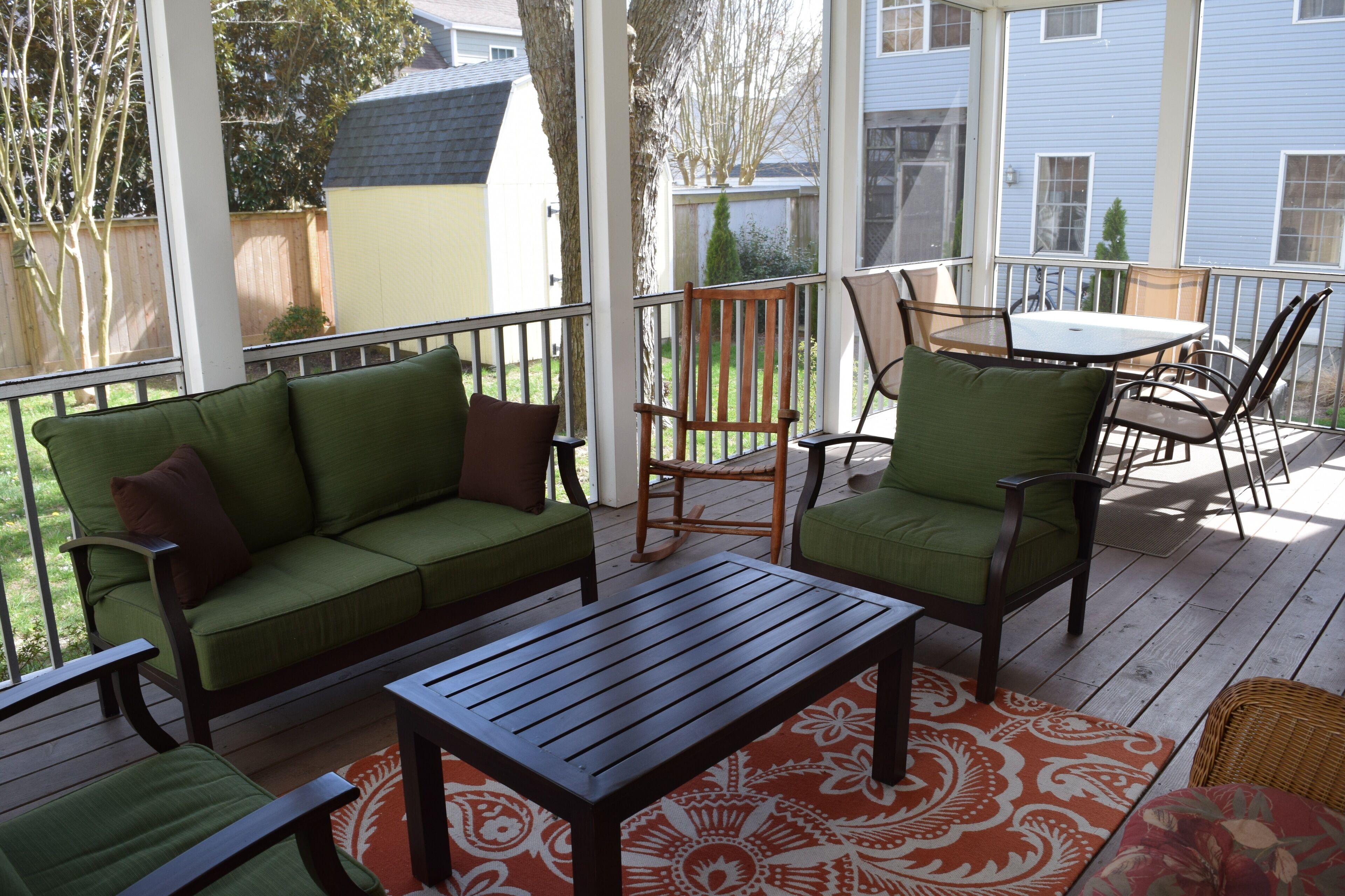 screened porch seating area and dining area beyond
