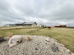 A residential area with houses, a gravel driveway, and a rock with 'LAKEVIEW OASIS' text.