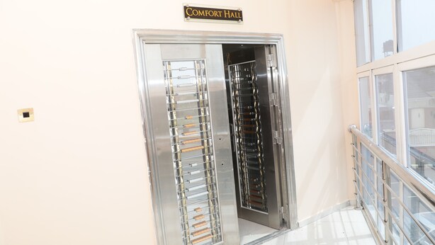 A metallic elevator with a sign above it reading "Comfort Hall." - Glo-ran Hotel and Event Place (Owerri)
