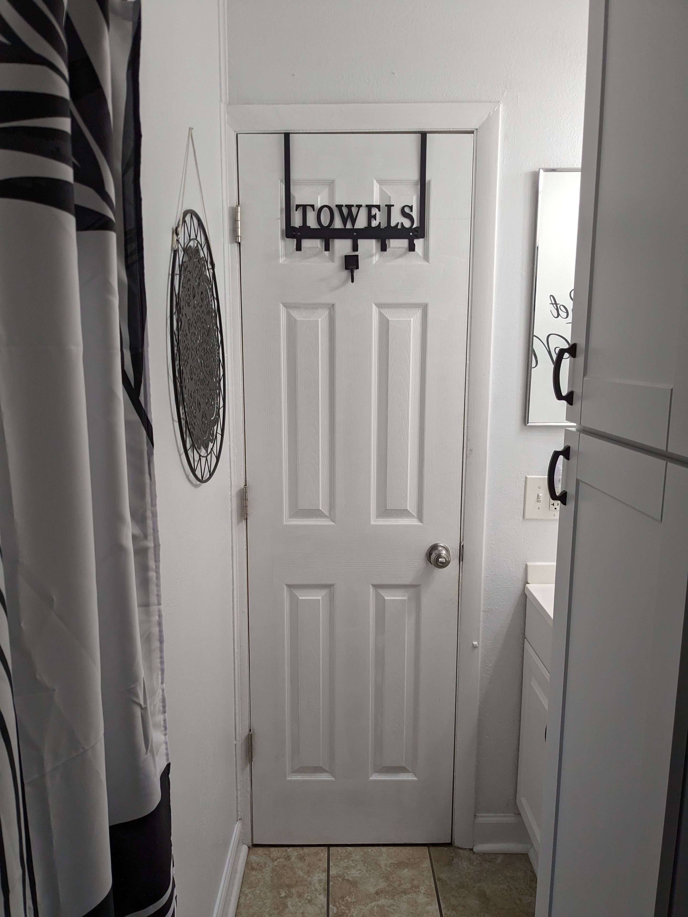 A white door with a sign above it that reads "TOWELS".