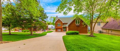 A suburban house with a front yard, a driveway, and a lawn.