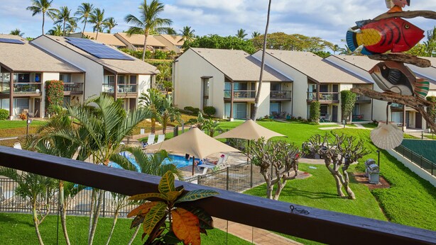 A hotel with multiple buildings, a swimming pool, and palm trees. - Just Steps to Kamaole III Beach!!! (Kihei, Maui)