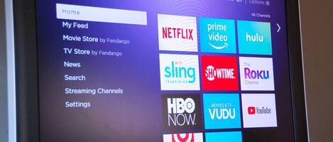A Roku interface with various streaming channels like Netflix, Hulu, and Prime Video.